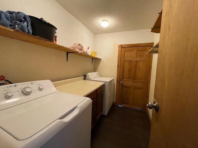 119 Village Rd, Steuben, ME 04680 - laundry area featuring washing machine and clothes dryer and a textured ceiling