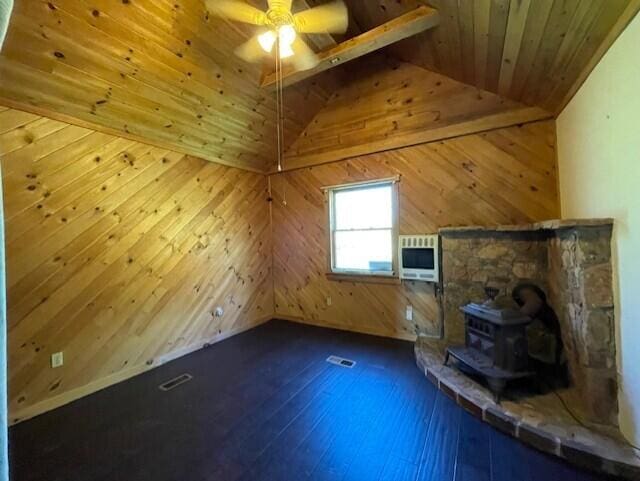 119 Village Rd, Steuben, ME 04680 - bonus room featuring a wood stove, wooden ceiling, heating unit, lofted ceiling, and ceiling fan