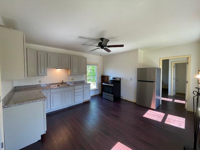 119 Village Rd, Steuben, ME 04680 - kitchen featuring appliances with stainless steel finishes, a sink, ceiling fan, dark wood-style flooring, and baseboards