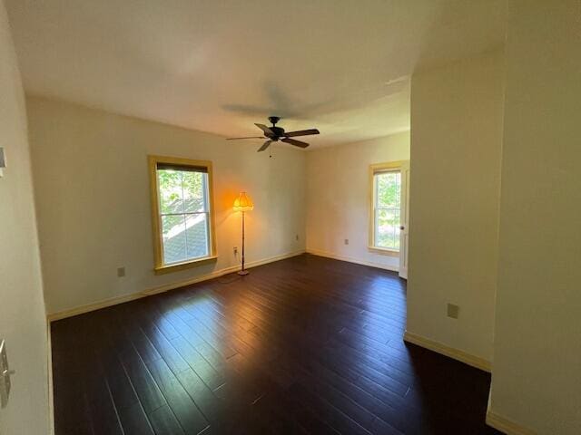 119 Village Rd, Steuben, ME 04680 - unfurnished room featuring healthy amount of natural light, baseboards, dark wood finished floors, and a ceiling fan