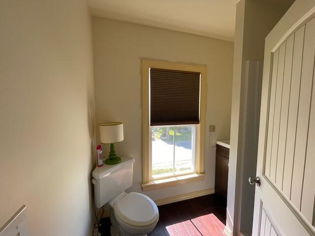 119 Village Rd, Steuben, ME 04680 - bathroom with toilet, vanity, baseboards, and wood finished floors
