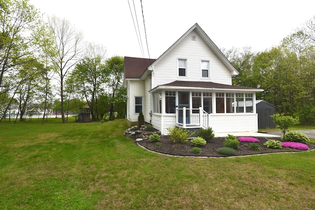 164 Nichols St, Pittsfield, ME 04967 - rear view of property featuring a sunroom, a shingled roof, and a lawn