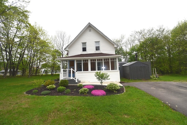 164 Nichols St, Pittsfield, ME 04967 - view of front of house with a sunroom and a front lawn