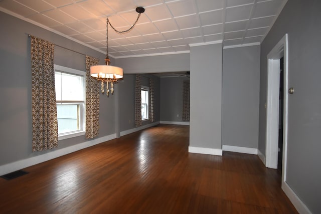 164 Nichols St, Pittsfield, ME 04967 - spare room with healthy amount of natural light, dark wood-style flooring, baseboards, a chandelier, and ornamental molding