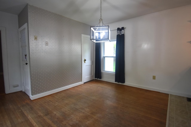 164 Nichols St, Pittsfield, ME 04967 - unfurnished dining area with wood finished floors, baseboards, and wallpapered walls