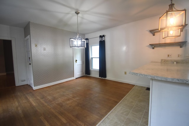 164 Nichols St, Pittsfield, ME 04967 - unfurnished dining area featuring a chandelier, baseboards, and wood finished floors