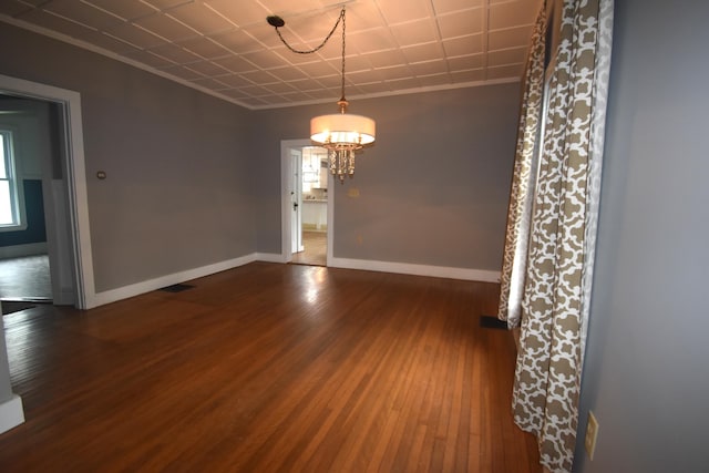 164 Nichols St, Pittsfield, ME 04967 - empty room with wood-type flooring, a chandelier, baseboards, and plenty of natural light