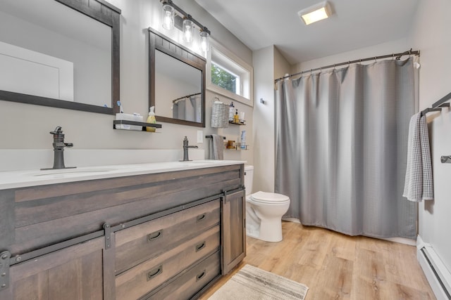 67 Overlook Rd, Windham, ME 04062 - full bath featuring baseboard heating, double vanity, wood finished floors, toilet, and a shower with curtain