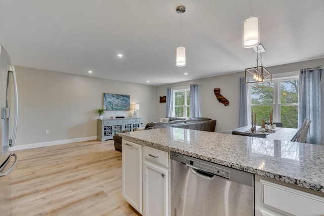 67 Overlook Rd, Windham, ME 04062 - kitchen with appliances with stainless steel finishes, light wood-type flooring, light stone counters, white cabinetry, and baseboards