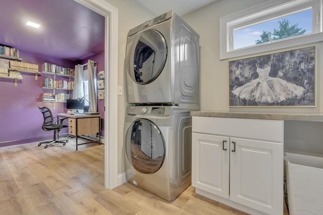 67 Overlook Rd, Windham, ME 04062 - laundry area with stacked washer / drying machine, an office area, light wood-type flooring, cabinet space, and baseboards
