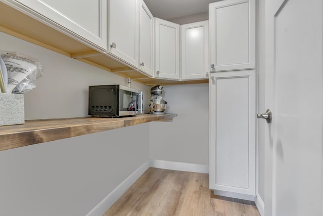 67 Overlook Rd, Windham, ME 04062 - kitchen featuring light wood-style floors, white cabinetry, baseboards, and light countertops