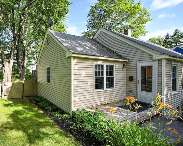 28 Colonial Rd, Westbrook, ME 04092 - view of home's exterior featuring a chimney and a shingled roof