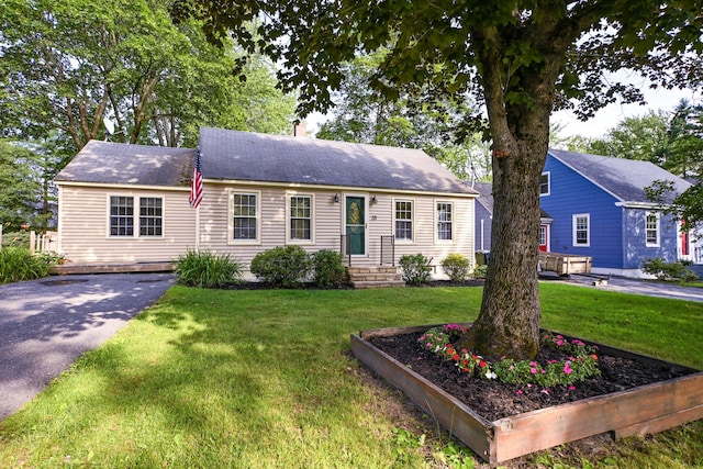 28 Colonial Rd, Westbrook, ME 04092 - view of front of house with driveway, a front lawn, and a chimney