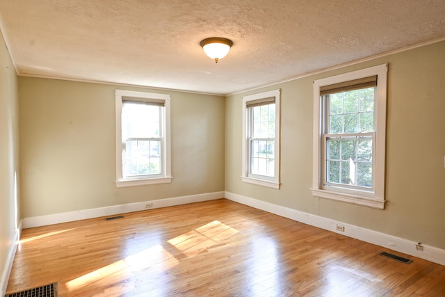 28 Colonial Rd, Westbrook, ME 04092 - spare room with a textured ceiling, light wood-type flooring, and crown molding