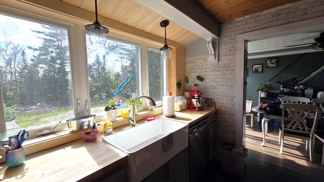 2670 Bennoch Rd, Old Town, ME 04468 - kitchen featuring brick wall, a sink, wood ceiling, dishwashing machine, and hanging light fixtures