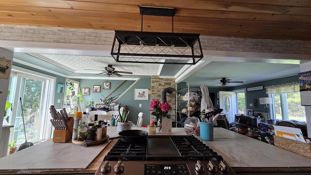2670 Bennoch Rd, Old Town, ME 04468 - kitchen with a ceiling fan, cooktop, brick wall, and open floor plan
