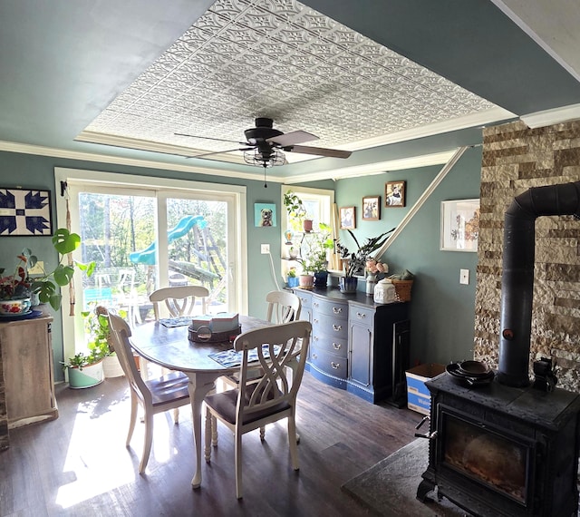 2670 Bennoch Rd, Old Town, ME 04468 - dining room featuring a wood stove, ornamental molding, wood finished floors, and a ceiling fan