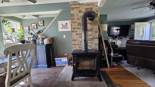 2670 Bennoch Rd, Old Town, ME 04468 - living area with a wood stove, healthy amount of natural light, wood finished floors, and ornamental molding