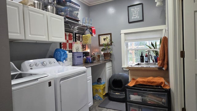 2670 Bennoch Rd, Old Town, ME 04468 - laundry room with washer and clothes dryer, ornamental molding, and cabinet space