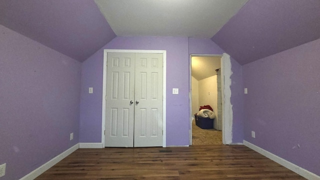 2670 Bennoch Rd, Old Town, ME 04468 - unfurnished bedroom featuring wood finished floors, lofted ceiling, a closet, and baseboards