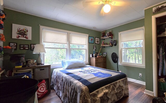 2670 Bennoch Rd, Old Town, ME 04468 - bedroom featuring crown molding, dark wood-style flooring, ceiling fan, and baseboards