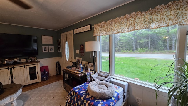2670 Bennoch Rd, Old Town, ME 04468 - living area featuring wainscoting, wood finished floors, and ornamental molding