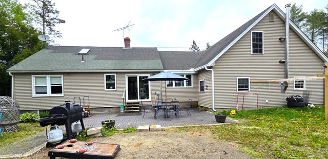 2670 Bennoch Rd, Old Town, ME 04468 - rear view of property featuring entry steps, a patio, a chimney, and roof with shingles