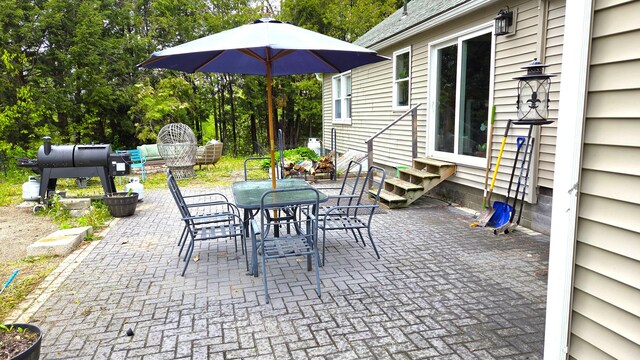 2670 Bennoch Rd, Old Town, ME 04468 - view of patio featuring entry steps, view of scattered trees, and outdoor dining area