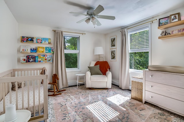 6 Emerald Ct, Berwick, ME 03901 - bedroom featuring a crib, baseboard heating, a ceiling fan, and baseboards