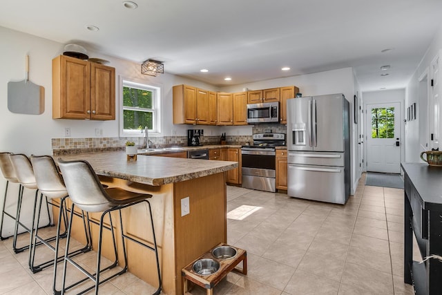 6 Emerald Ct, Berwick, ME 03901 - kitchen featuring stainless steel appliances, a peninsula, healthy amount of natural light, tasteful backsplash, and recessed lighting