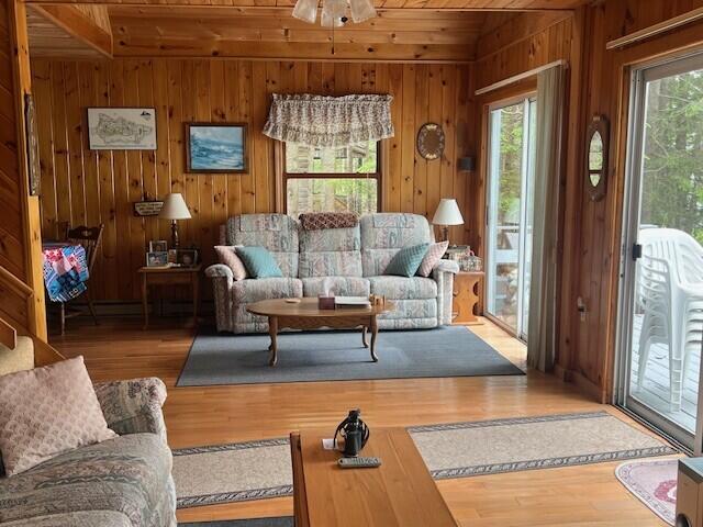 166 Ridge Rd, Frye Island, ME 04071 - living room with wood ceiling, wooden walls, wood finished floors, and a ceiling fan