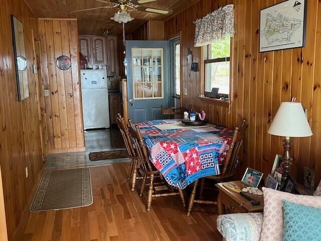 166 Ridge Rd, Frye Island, ME 04071 - dining room with wood walls, wood finished floors, wood ceiling, and ceiling fan
