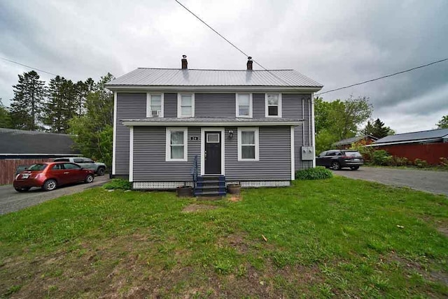 29 Columbia St, Houlton, ME 04730 - view of front of property featuring entry steps, a chimney, a front yard, and metal roof