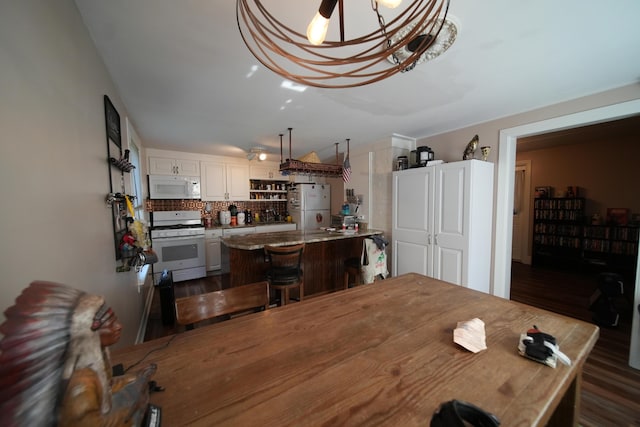 29 Columbia St, Houlton, ME 04730 - dining area with dark wood-type flooring and a chandelier