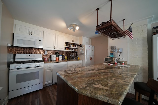 29 Columbia St, Houlton, ME 04730 - kitchen with white appliances, a sink, a peninsula, decorative backsplash, and dark wood finished floors