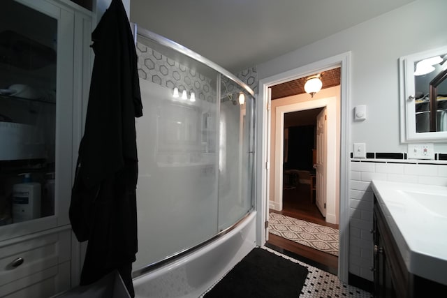 29 Columbia St, Houlton, ME 04730 - full bath with vanity, combined bath / shower with glass door, and wood finished floors