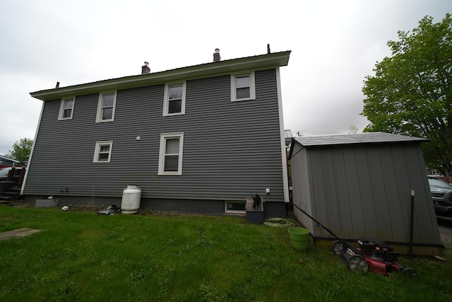 29 Columbia St, Houlton, ME 04730 - back of property with a chimney and a lawn