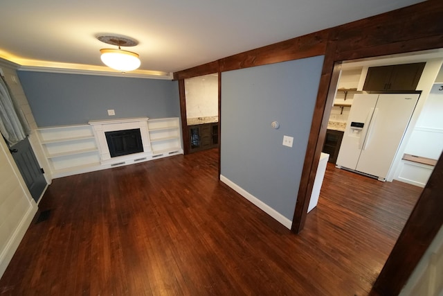 29 Columbia St, Houlton, ME 04730 - unfurnished living room featuring a fireplace, dark wood-style floors, and baseboards