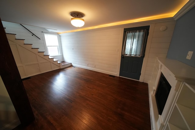 29 Columbia St, Houlton, ME 04730 - entryway with stairway, dark wood-type flooring, a fireplace, and a decorative wall