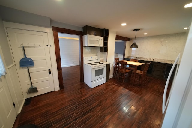 29 Columbia St, Houlton, ME 04730 - kitchen with white appliances, dark wood finished floors, light countertops, pendant lighting, and backsplash