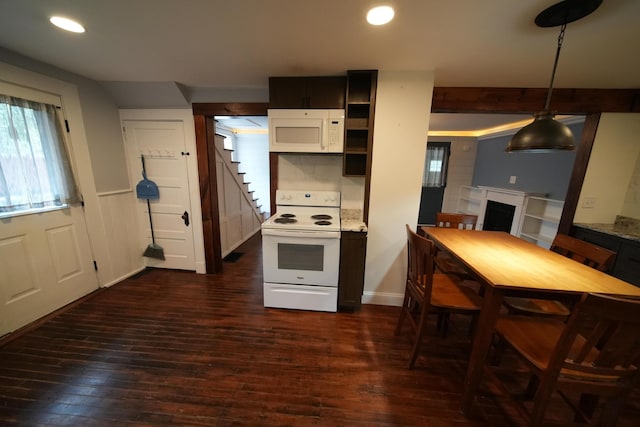 29 Columbia St, Houlton, ME 04730 - kitchen with white appliances, dark wood-style floors, a fireplace, recessed lighting, and decorative light fixtures