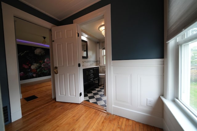 29 Columbia St, Houlton, ME 04730 - unfurnished bedroom featuring ornamental molding, wood finished floors, and connected bathroom