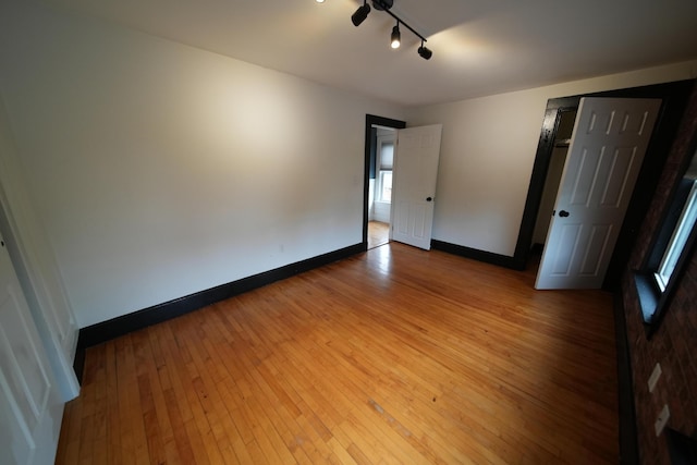 29 Columbia St, Houlton, ME 04730 - unfurnished room with hardwood / wood-style floors, baseboards, and track lighting