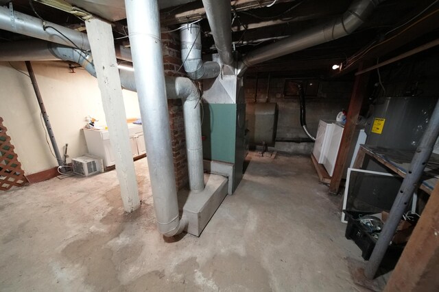 29 Columbia St, Houlton, ME 04730 - unfinished below grade area featuring washer and clothes dryer, electric water heater, and oil tank