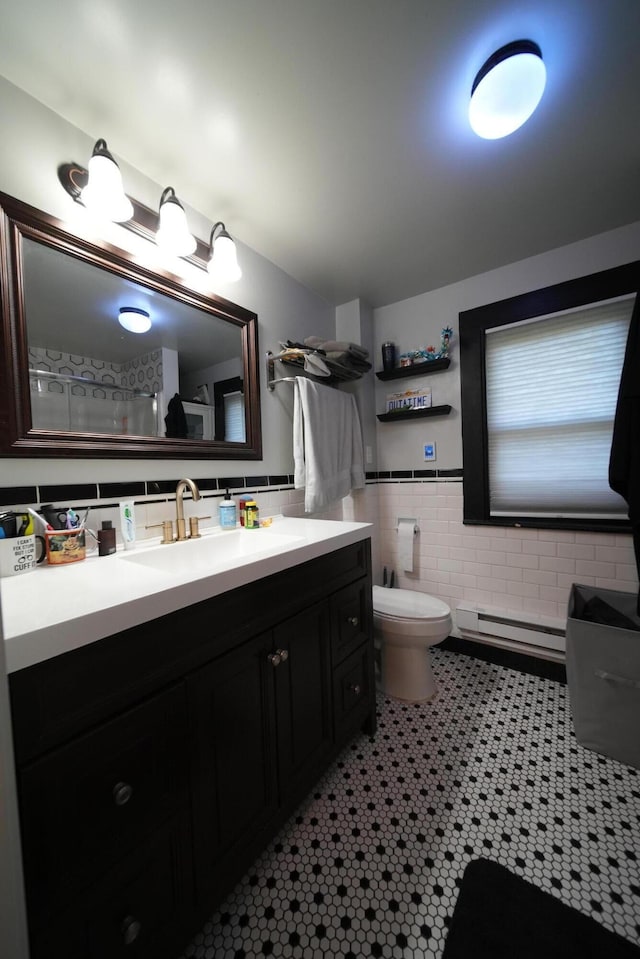 29 Columbia St, Houlton, ME 04730 - full bathroom with a baseboard heating unit, tile walls, toilet, and vanity