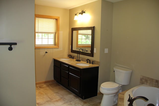 89 Drake Rd, Madison, ME 04950 - bathroom with toilet, a tub with jets, double vanity, and baseboards