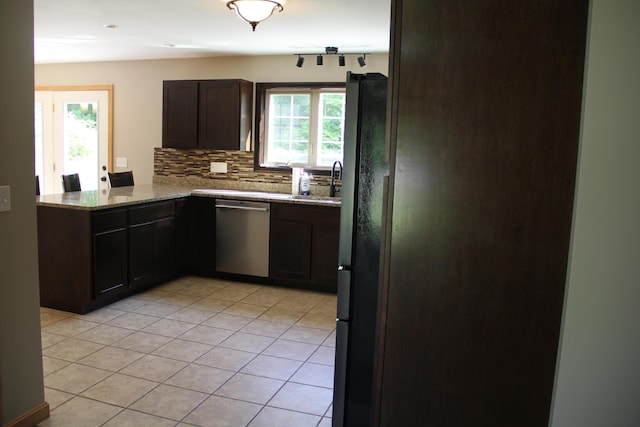 89 Drake Rd, Madison, ME 04950 - kitchen with stainless steel dishwasher, light stone counters, tasteful backsplash, light tile patterned flooring, and dark brown cabinetry