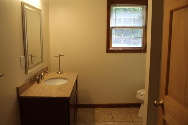 89 Drake Rd, Madison, ME 04950 - bathroom with toilet, vanity, baseboards, and tile patterned floors