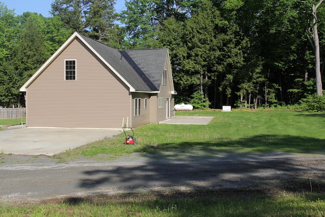 89 Drake Rd, Madison, ME 04950 - view of property exterior featuring a shingled roof and a yard