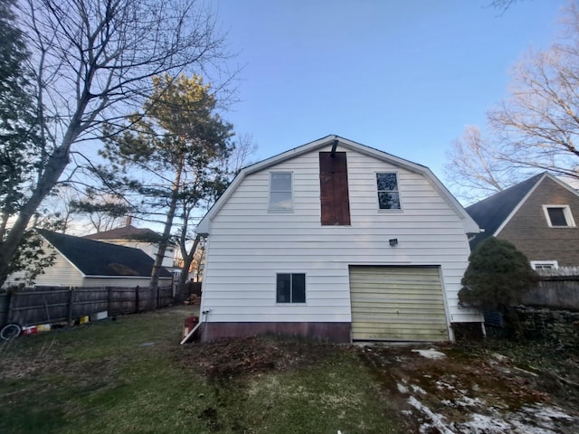 14 Somerset St, Millinocket, ME 04462 - rear view of property with a gambrel roof, driveway, and an attached garage